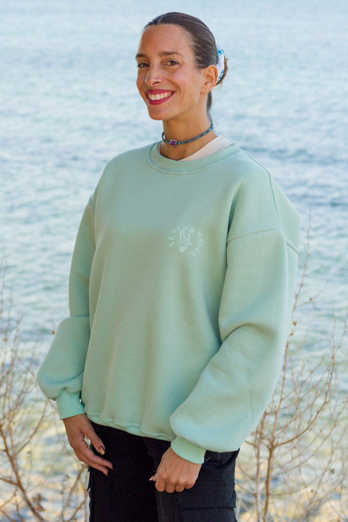 Close-up of the retro surf graphic on the Sevi Waves mint crewneck sweatshirt.