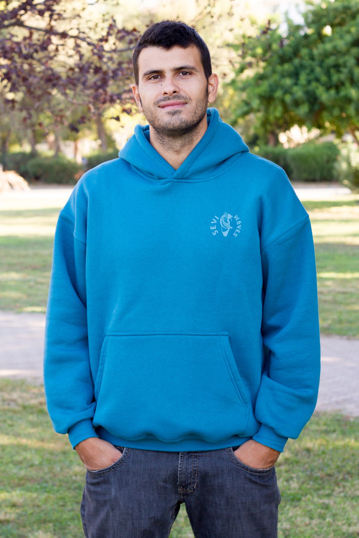Sevi Waves petrol oversized hoodie with a coastal palm trees and seashells graphic on the back.