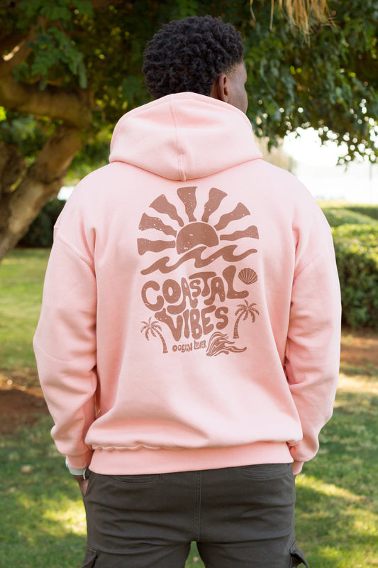 Back detail of a salmon Sevi Waves hoodie featuring palm trees and seashell illustrations.