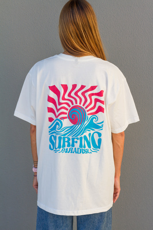 Person wearing a white t-shirt with a custom colorful graphic design on the back against a gray background