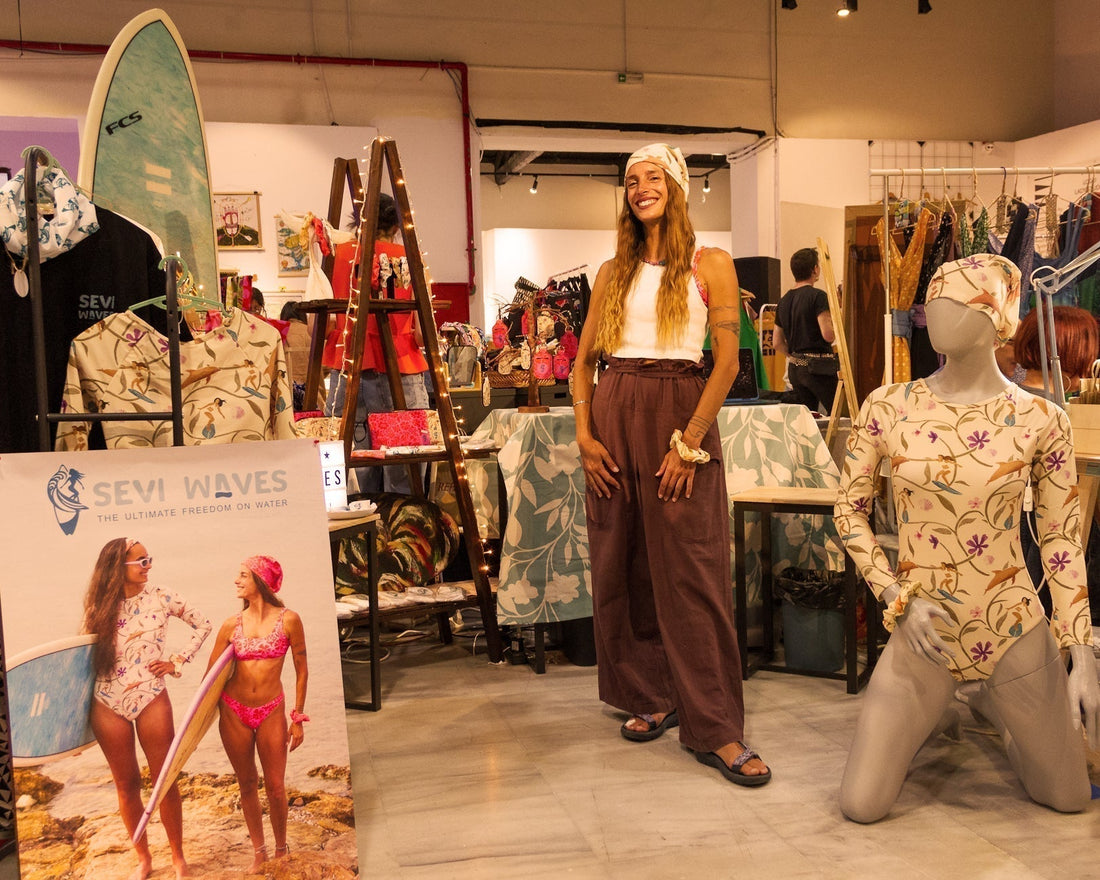 A lady standing in front of a indoor surfstyle shop.