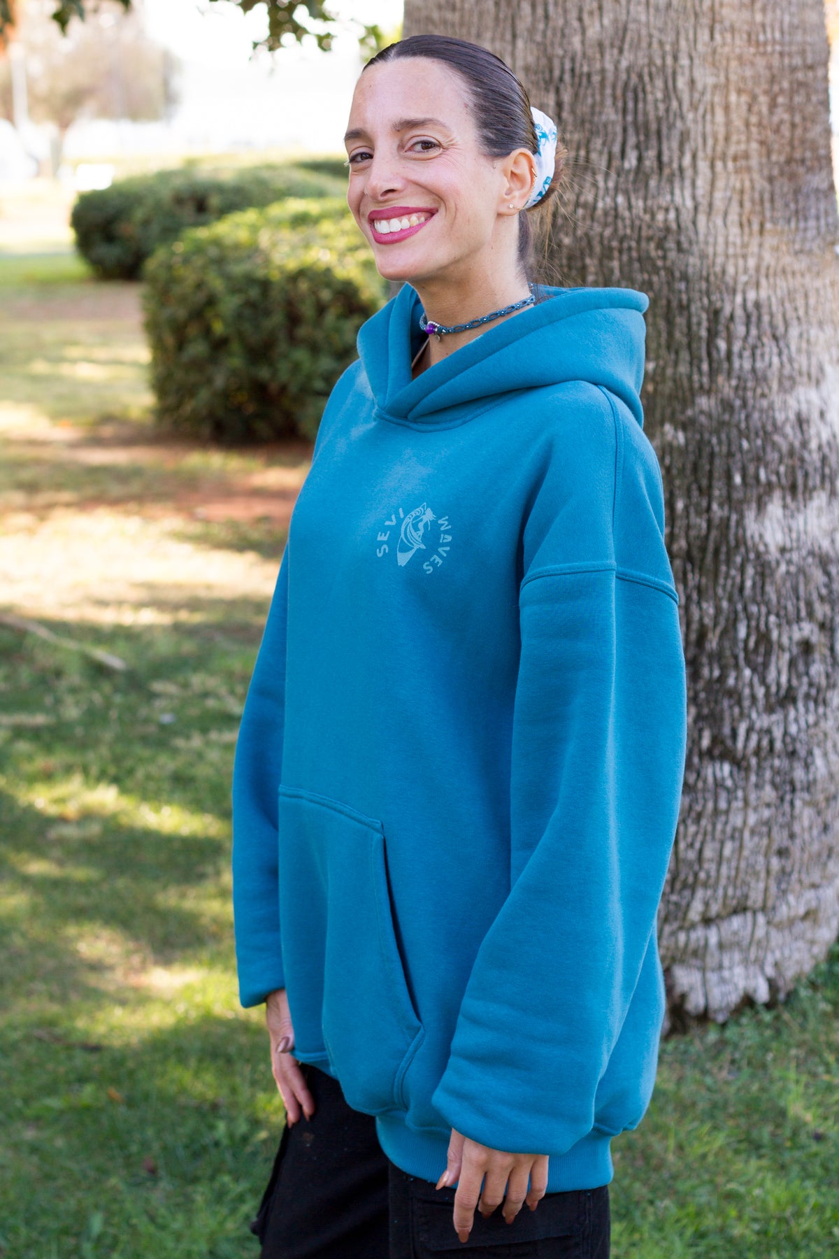 Petrol blue oversized sweatshirt with a vintage-inspired tropical palms and seashells print.