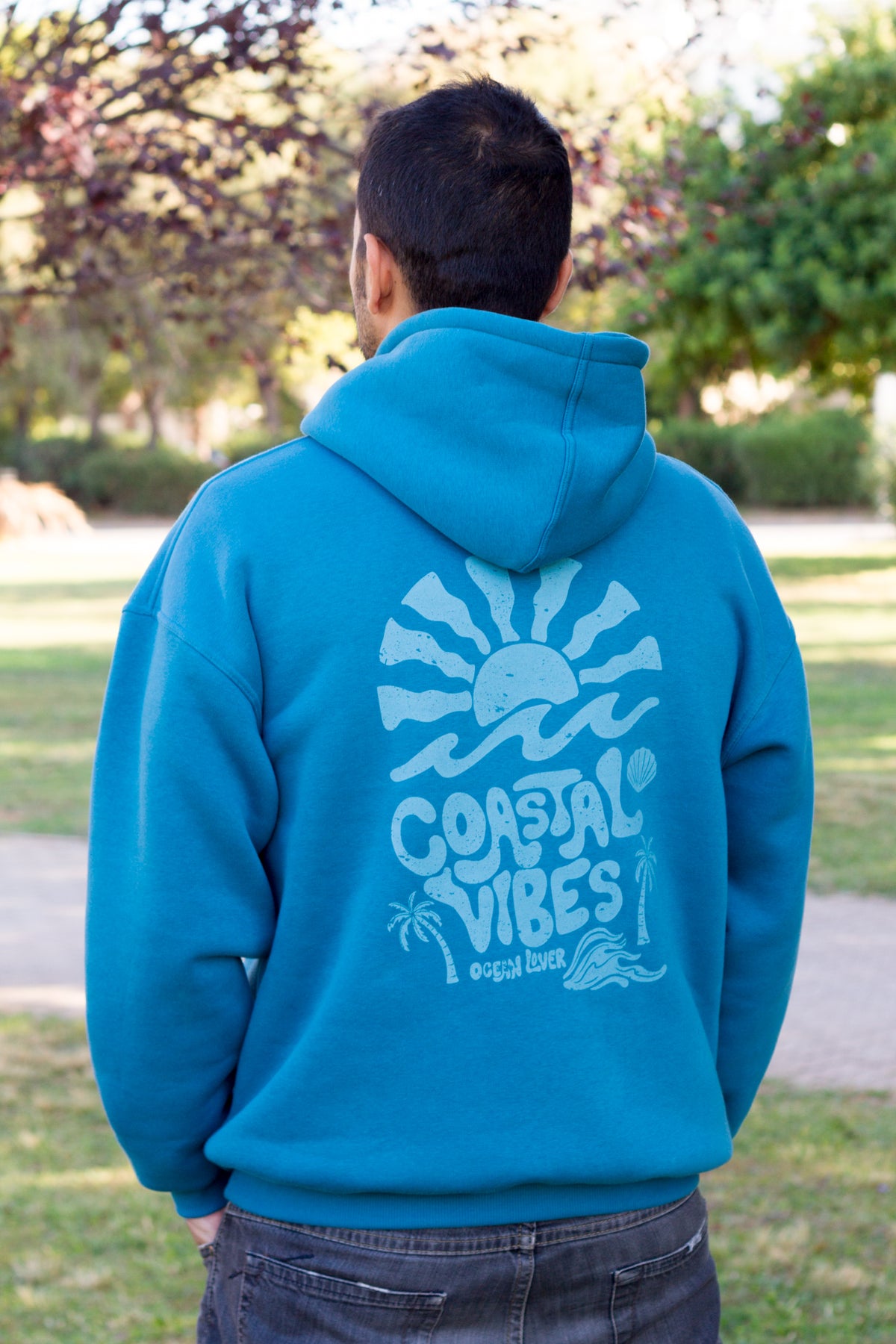Petrol oversized hoodie with a vintage seaside illustration from the TIDE SHIFT collection.