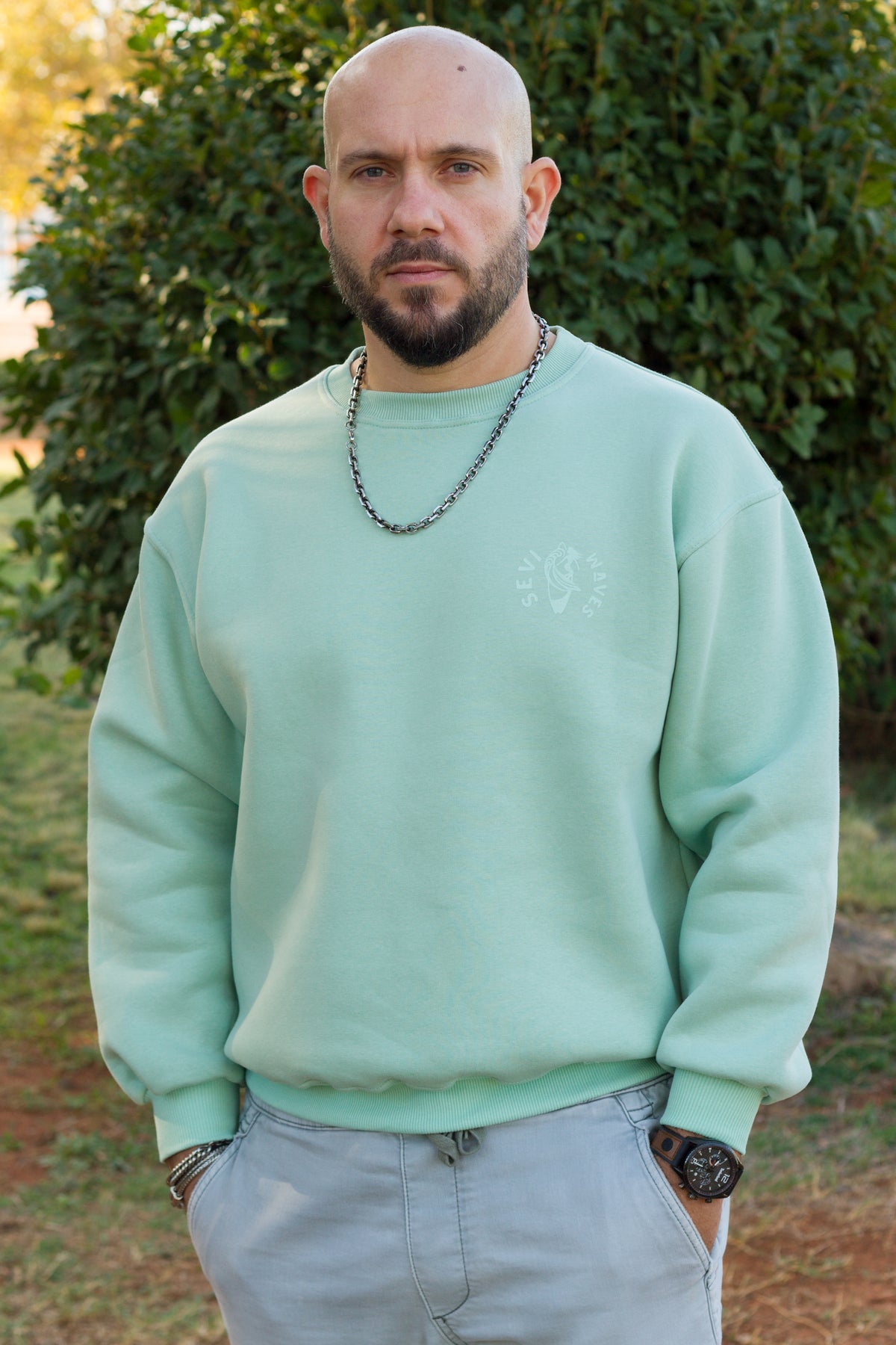 Close-up of the retro surf graphic on the Sevi Waves mint crewneck sweatshirt.