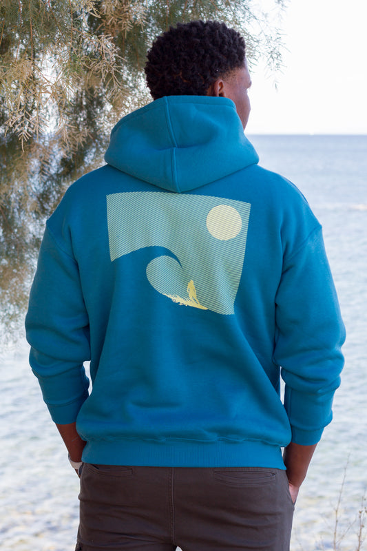 Back detail of a petrol Sevi Waves hoodie with a surf-inspired sunset and ocean print.