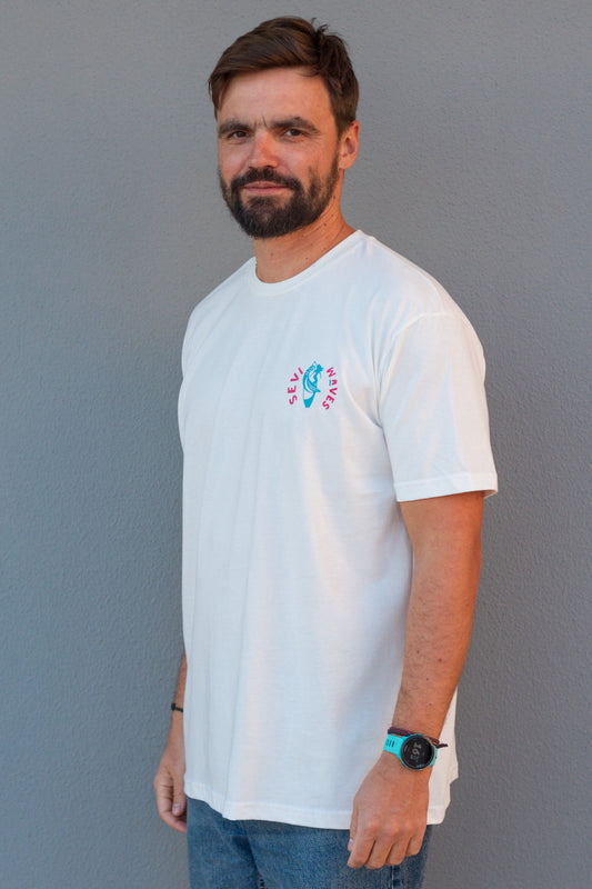 Man wearing a white t-shirt with a colorful custom design against a gray background